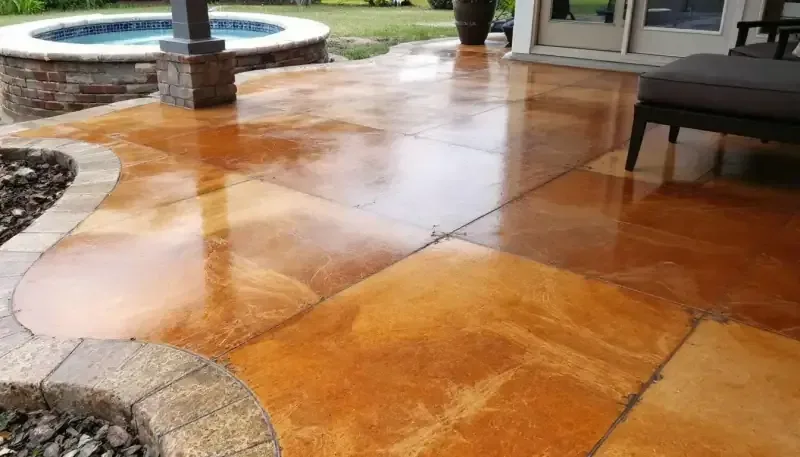 Acid-stained concrete patio with rich amber tones in Lawrence, KS